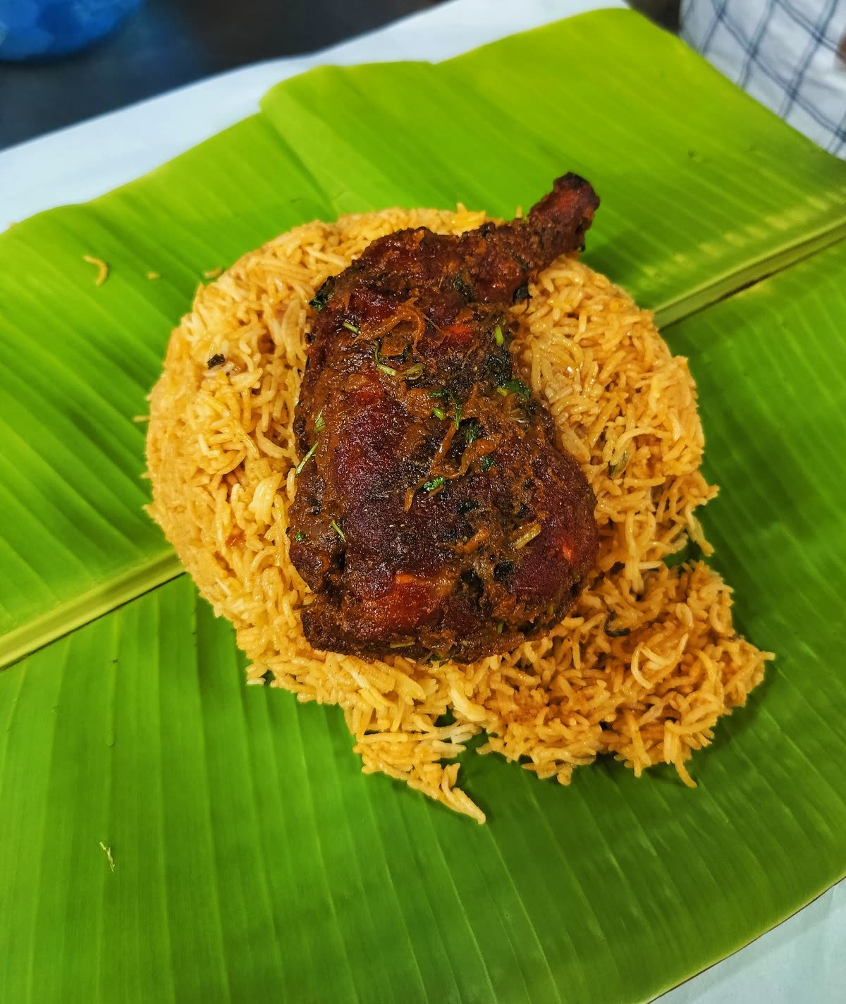 Biryani served on a banana leaf